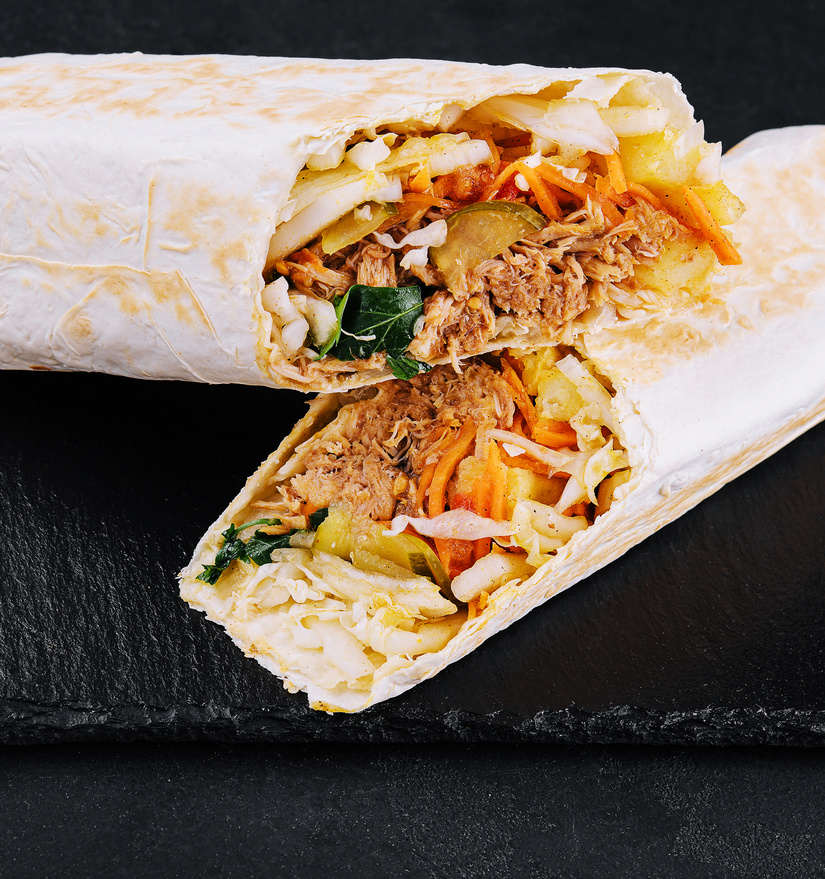 shawarma with chicken, cucumbers and fries.
